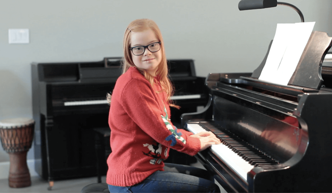 Girl with Down Syndrome playing a piano