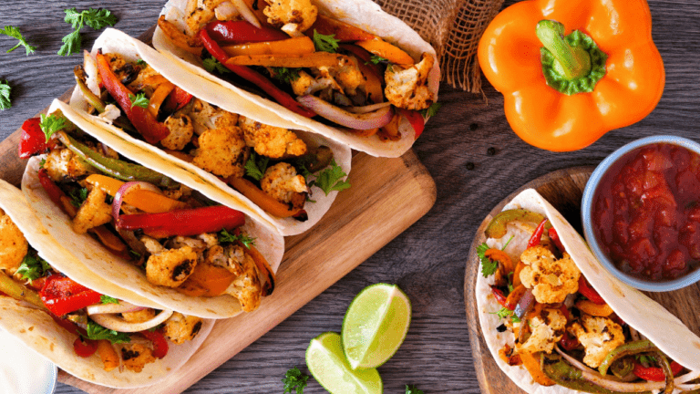 Healthy plant-based cauliflower fajitas, above view table scene over wood